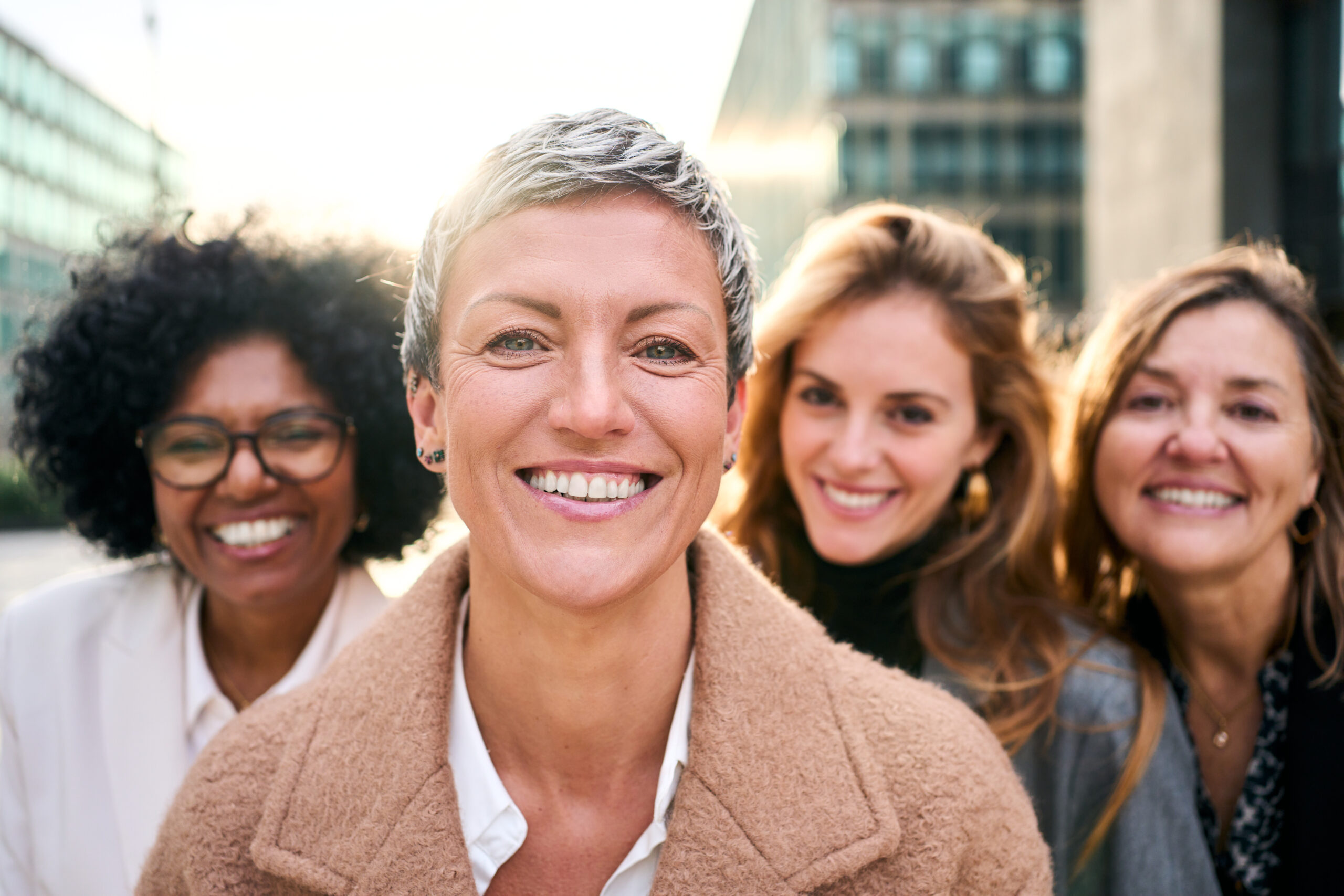 group of four women, smiling