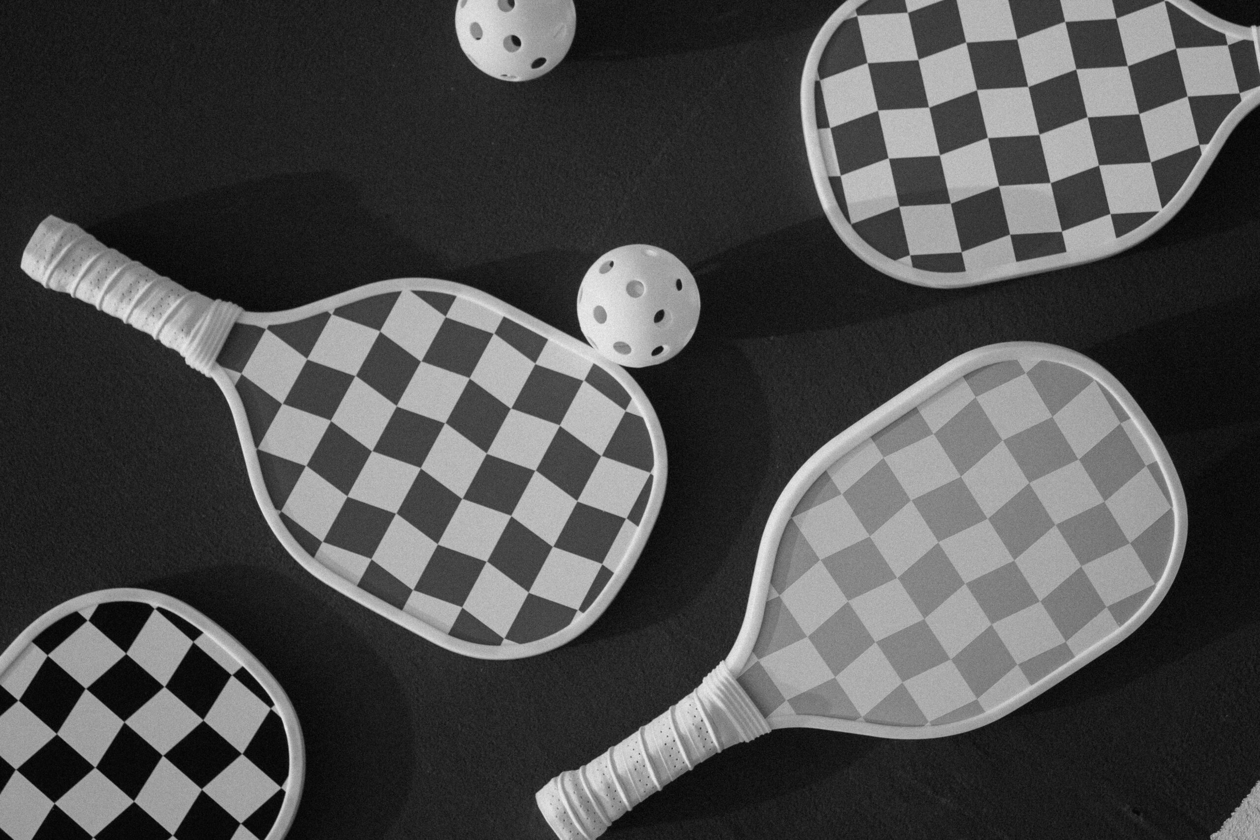 black and white paddleball set