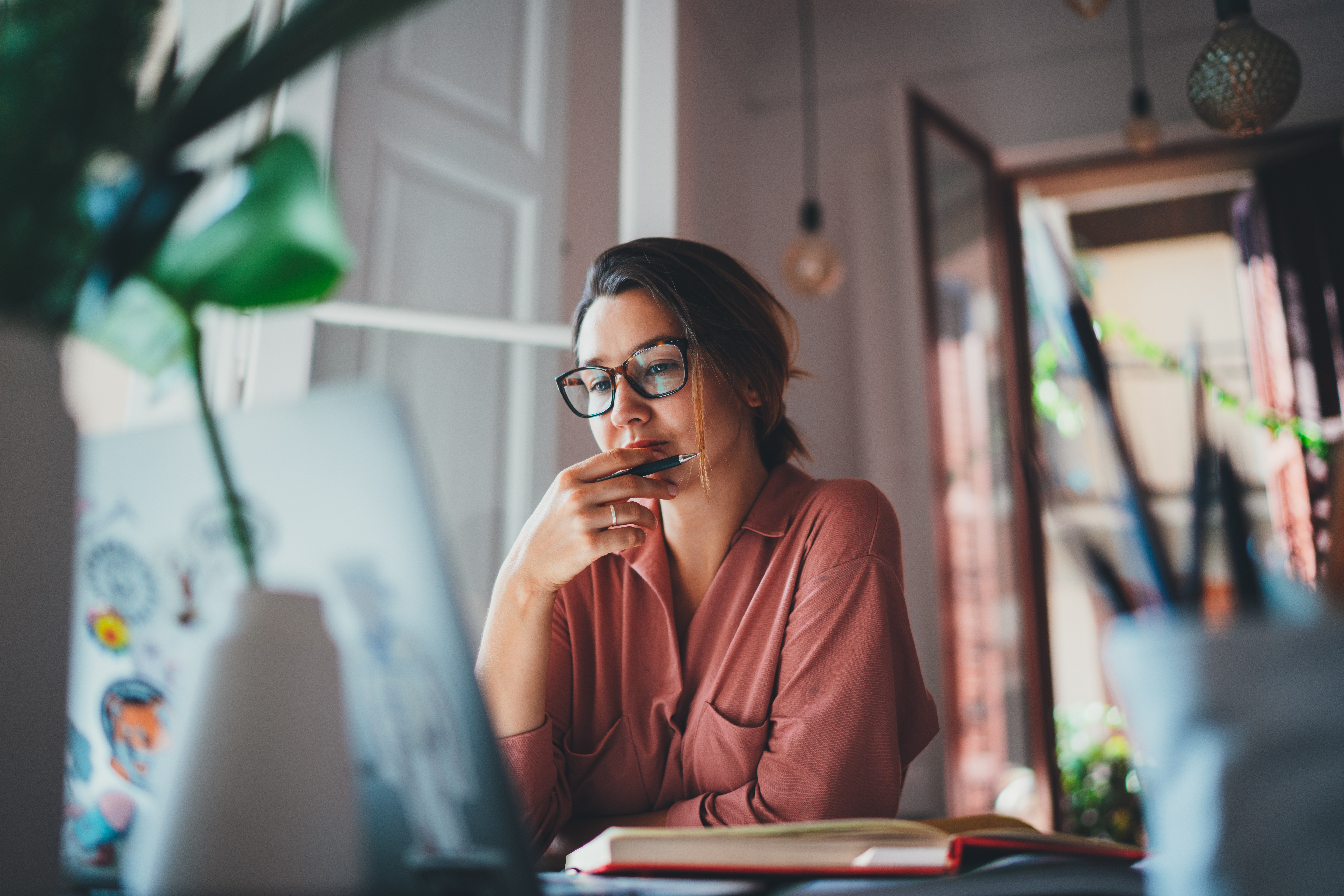 Businesswoman thinking about something while sitting front of a screen