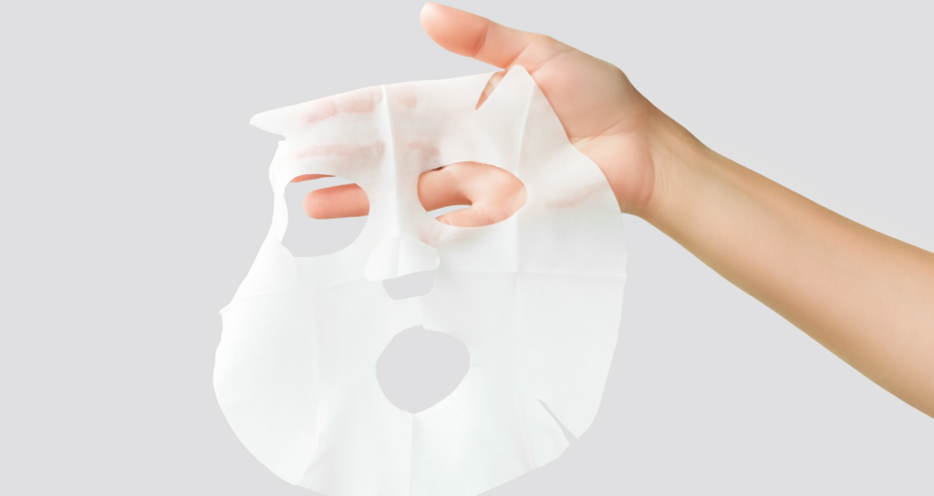 collagen sheet mask being held in a hand