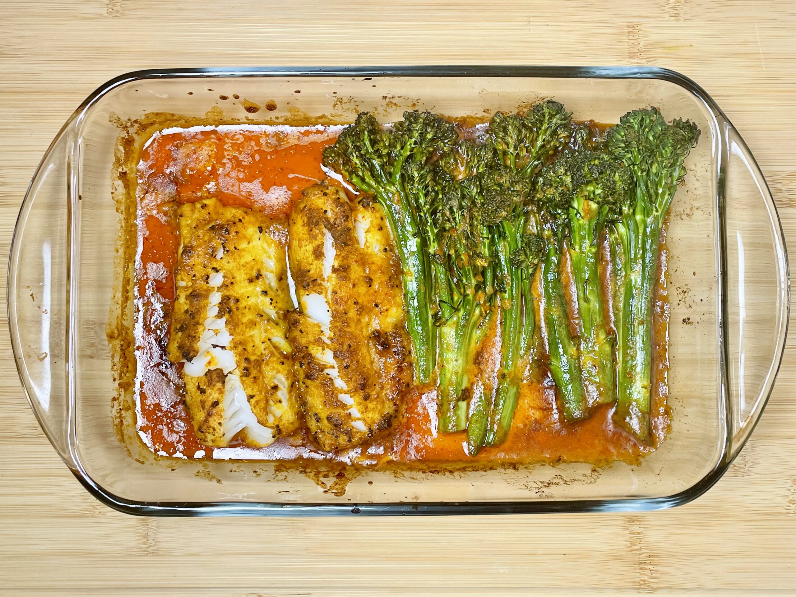 cooked cod with broocolini in broiling dish