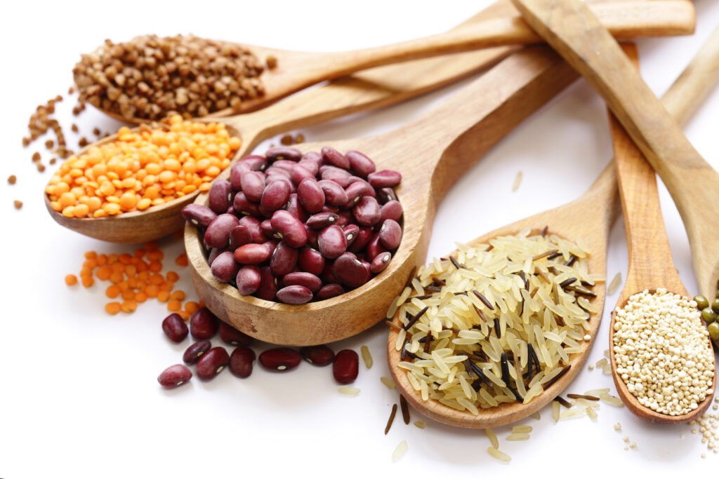 different beans, lentils, rice on a white background