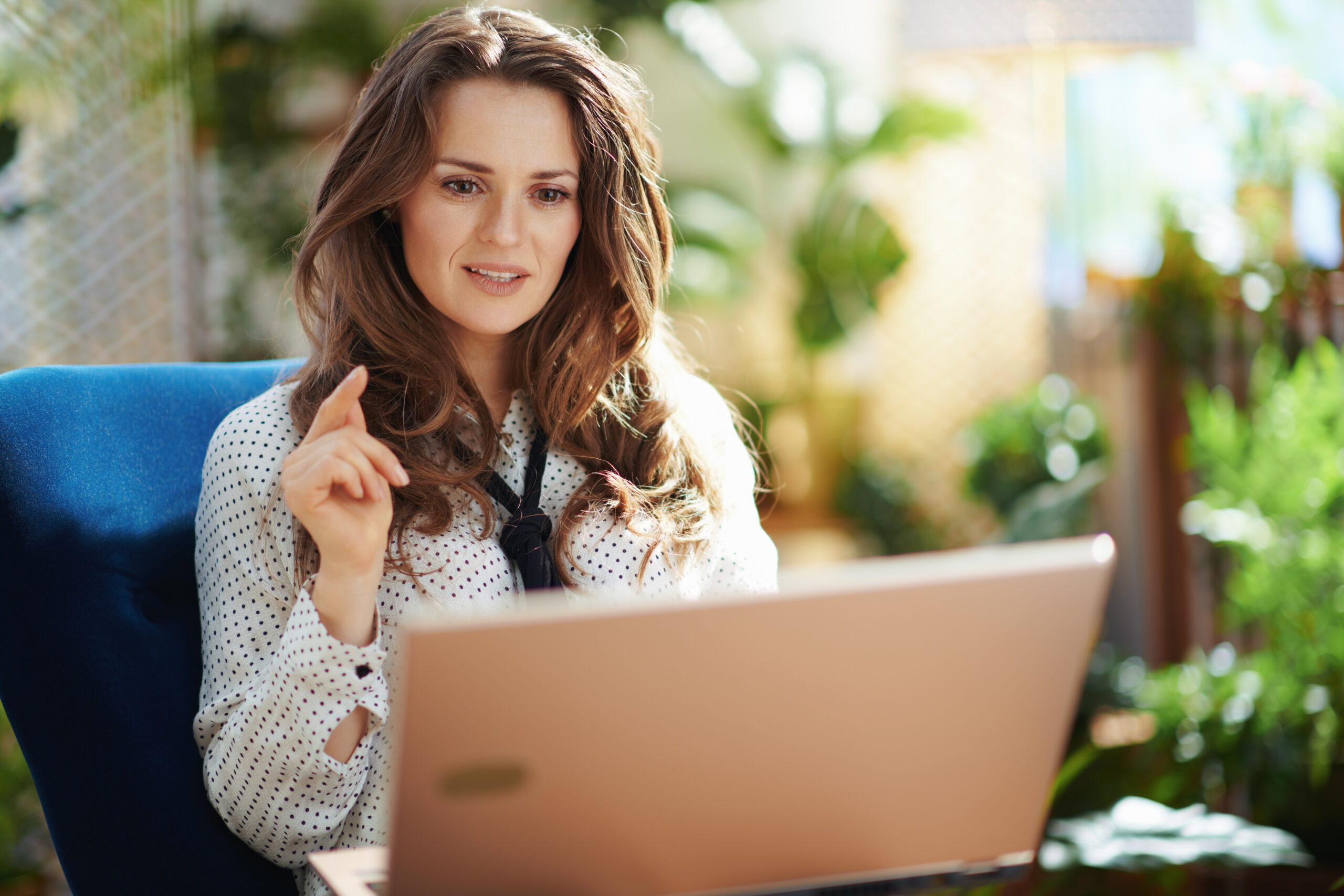 trendy woman in sunny day having web cam meeting