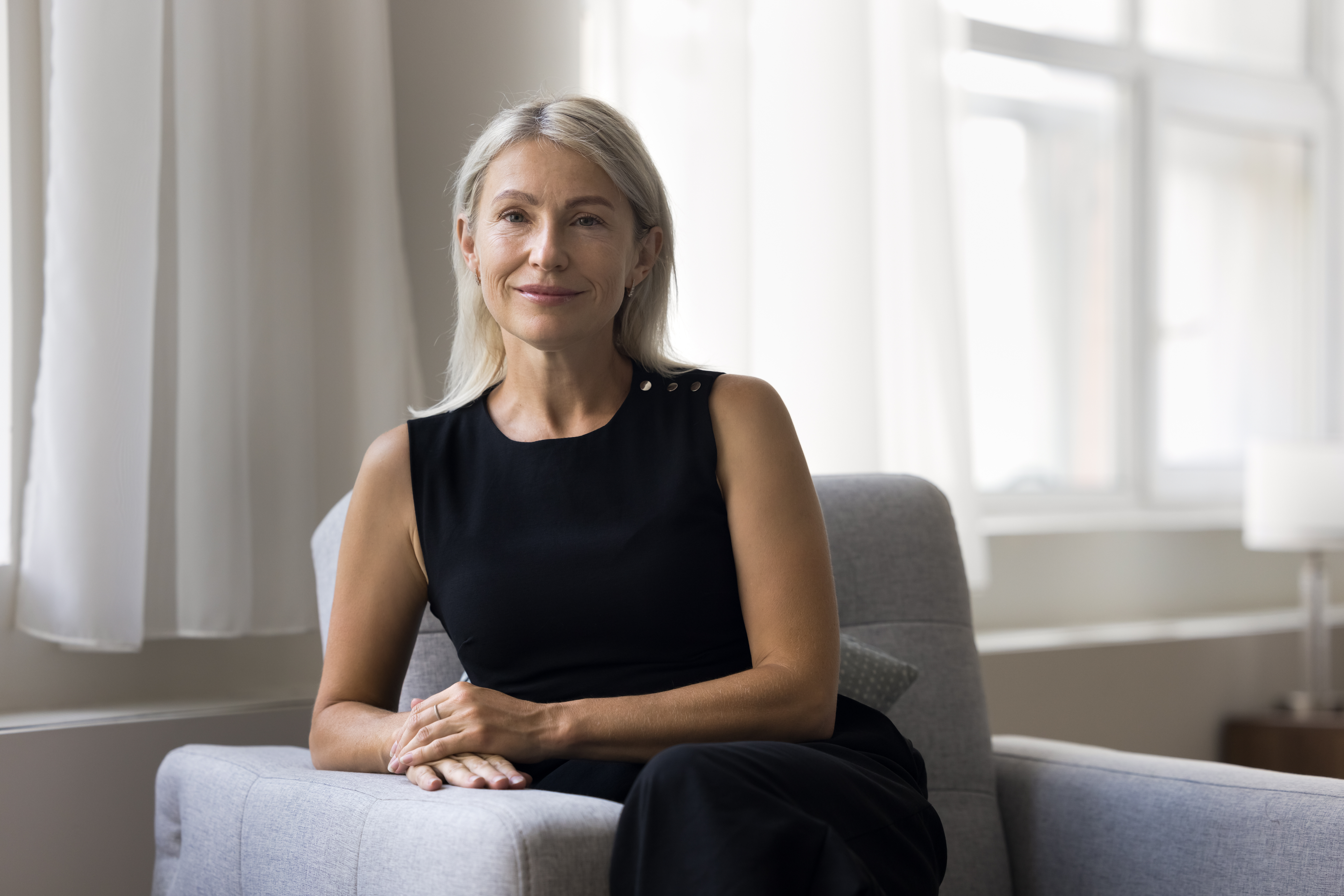 Portrait of beautiful middle-aged woman smile look at camera